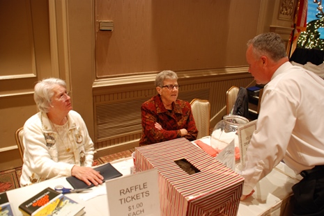 Volunteers at the Holiday Dinner raffle table. 