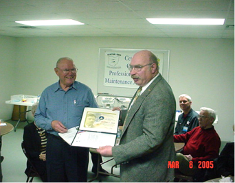 Inspector Roger Olson presents Charles Taylor Award to Cliff Marr.