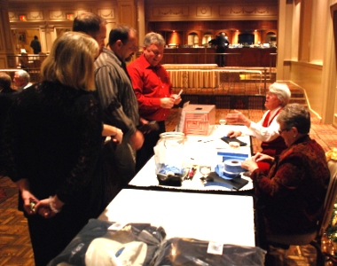 Volunteers and Guests at the Raffle table
